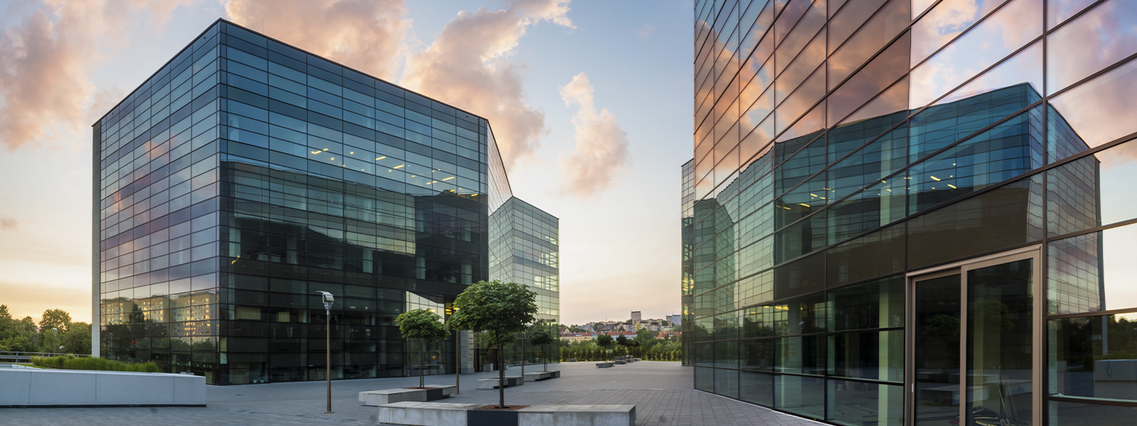 Modern commercial office complex with glass buildings and landscaped plaza representing comprehensive commercial property insurance coverage for business real estate