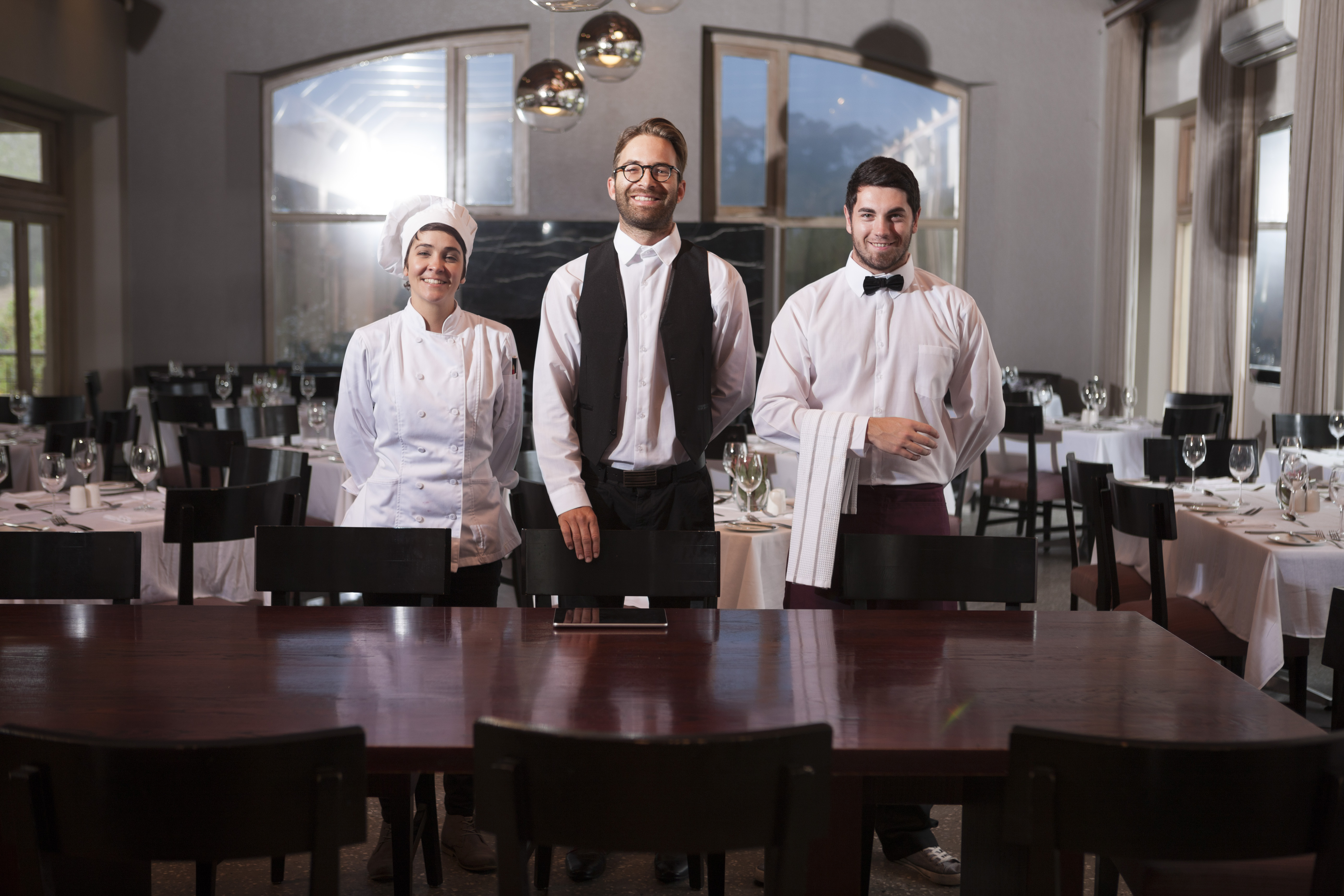 Professional restaurant staff team including chef and servers representing comprehensive restaurant and food industry insurance coverage