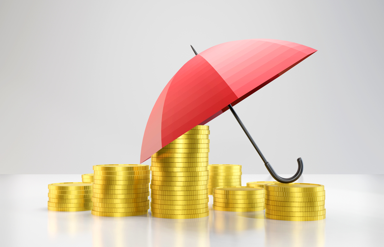 Red umbrella protecting stacks of golden coins representing financial asset protection through personal umbrella insurance